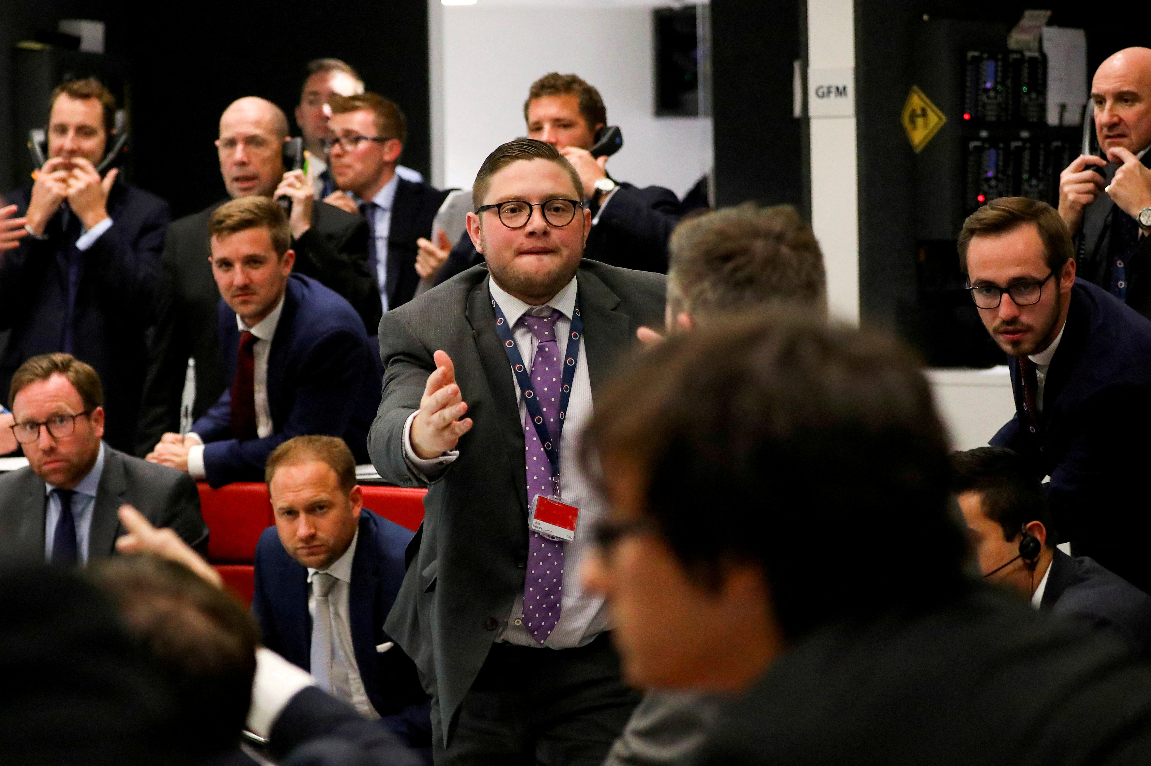 FILE PHOTO: Traders work on the floor of the London Metal Exchange