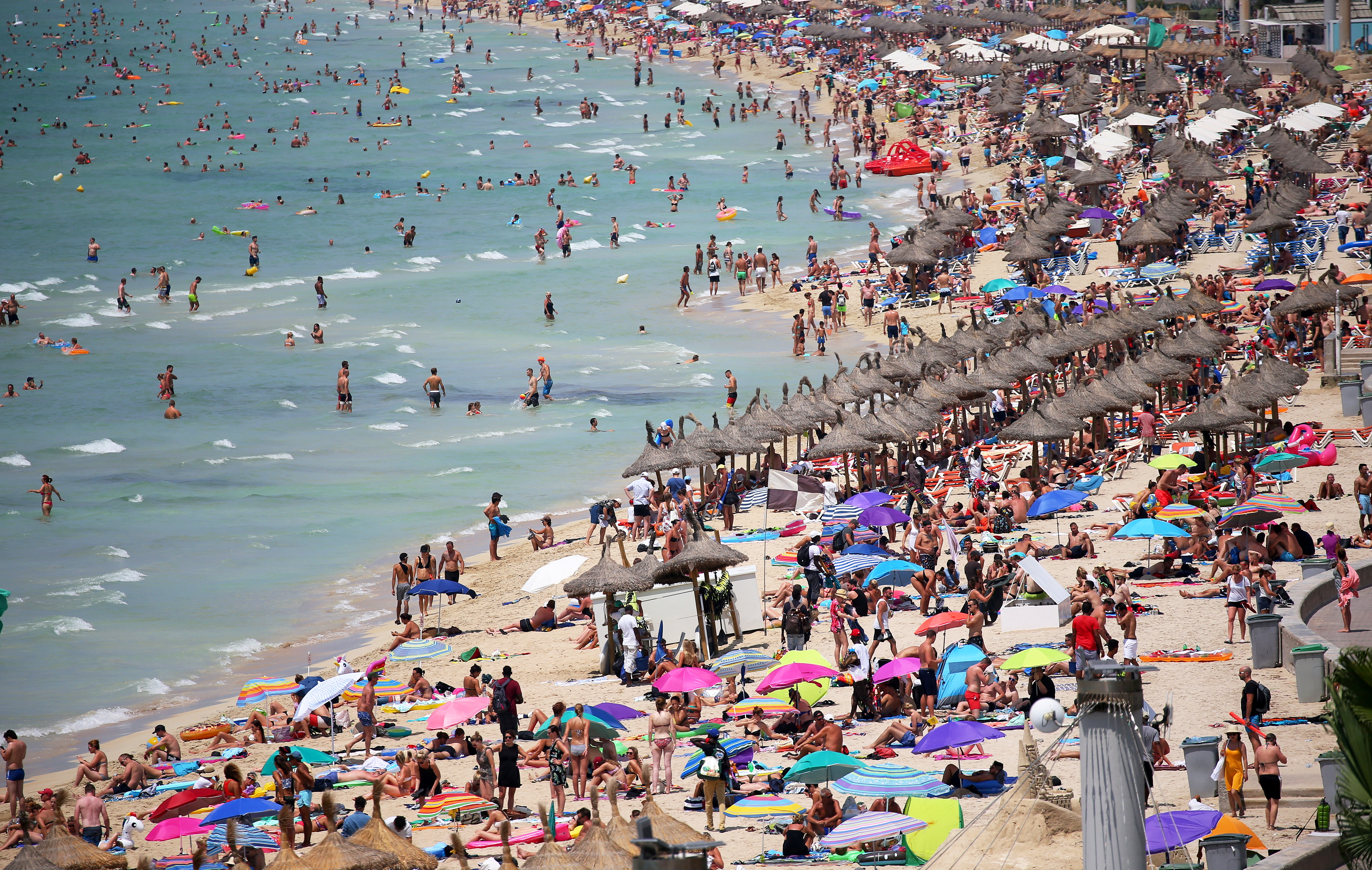 FILE PHOTO: Pre-pandemic tourists sunbathe in El Arenal beach in the island of Mallorca