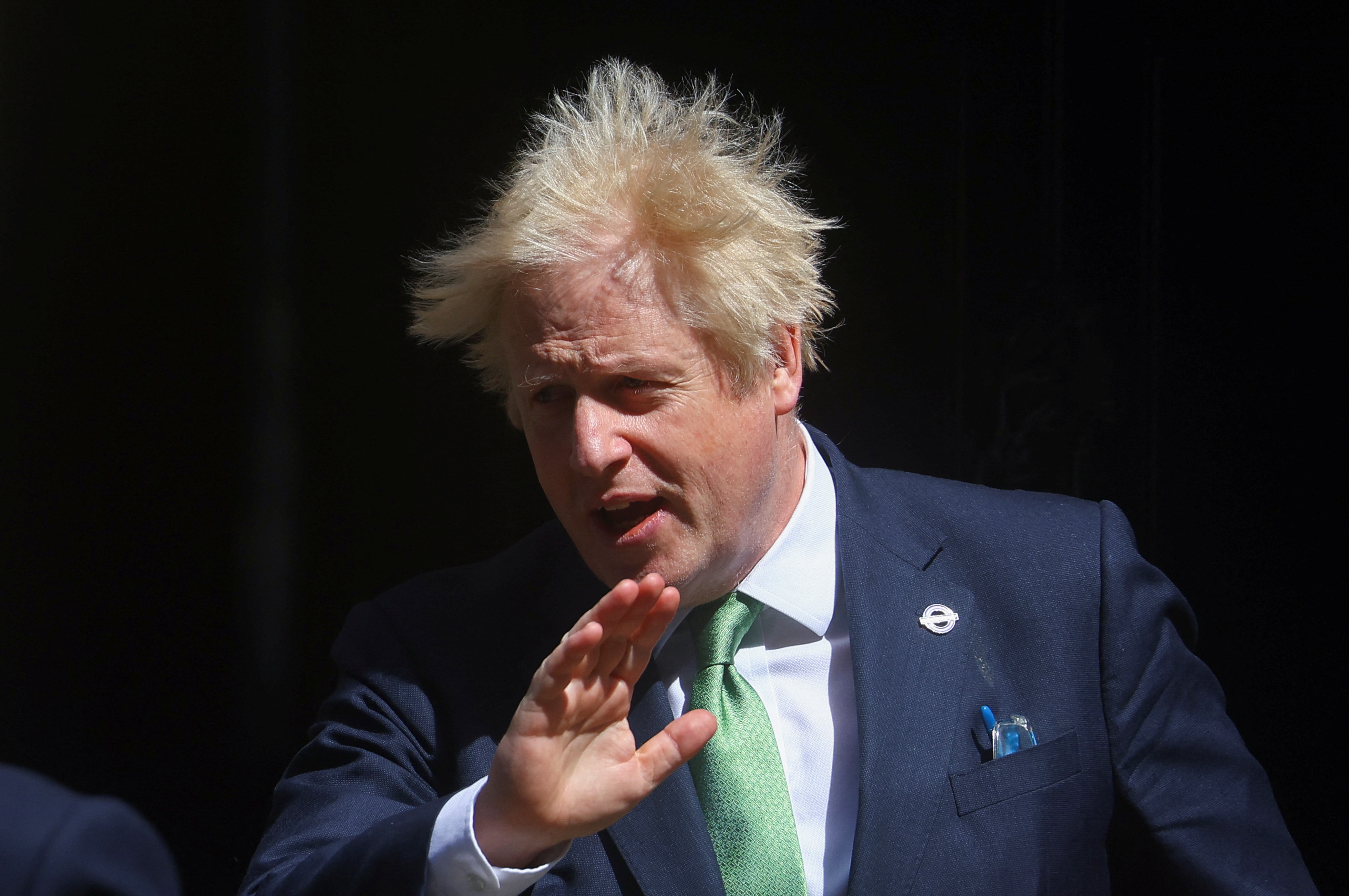 British PM Johnson leaves Downing Street to take questions in parliament, in London