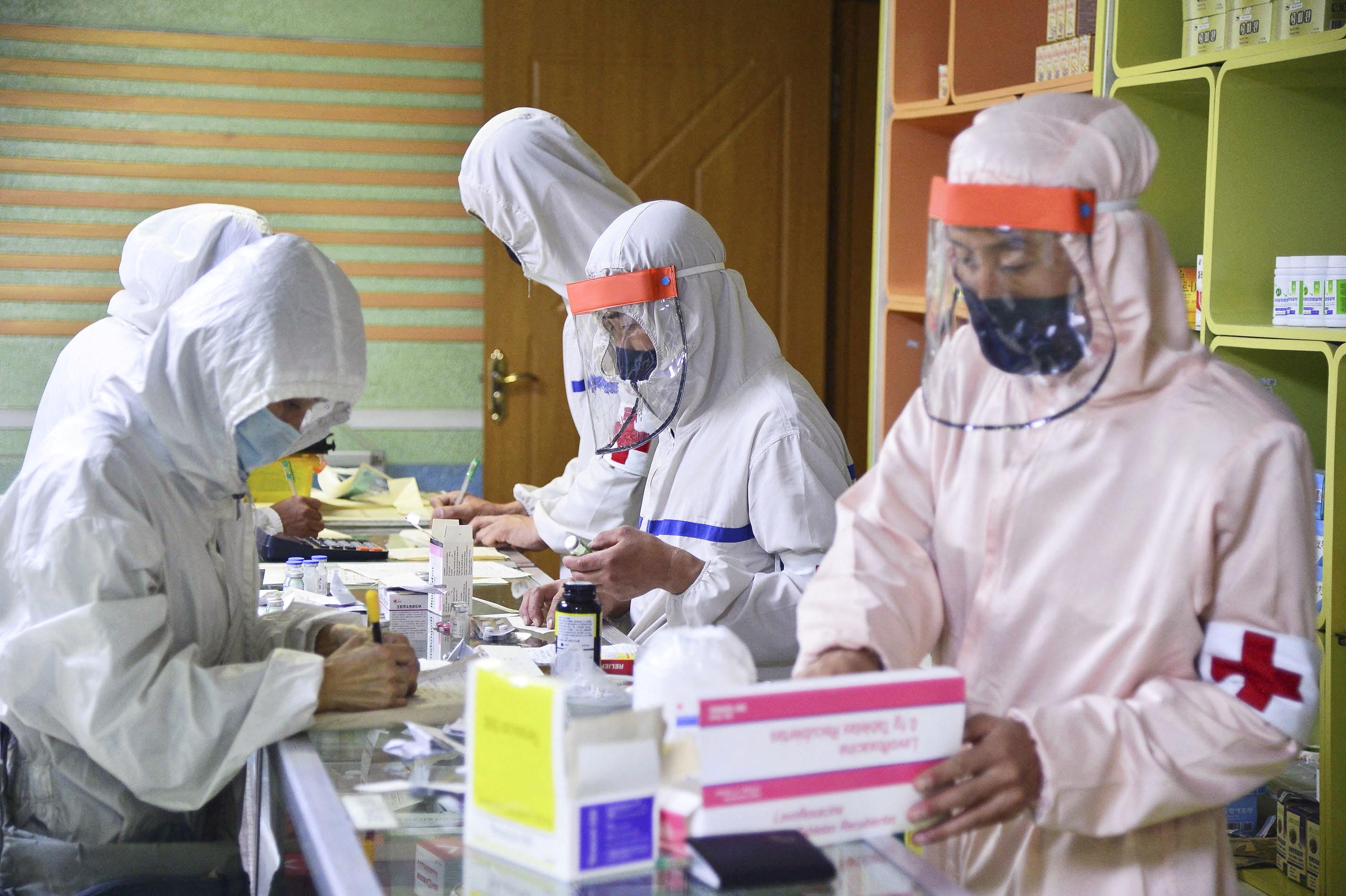 Members of North Korean army supply medicines to residents at pharmacy amid fears over COVID-19, in Pyongyang