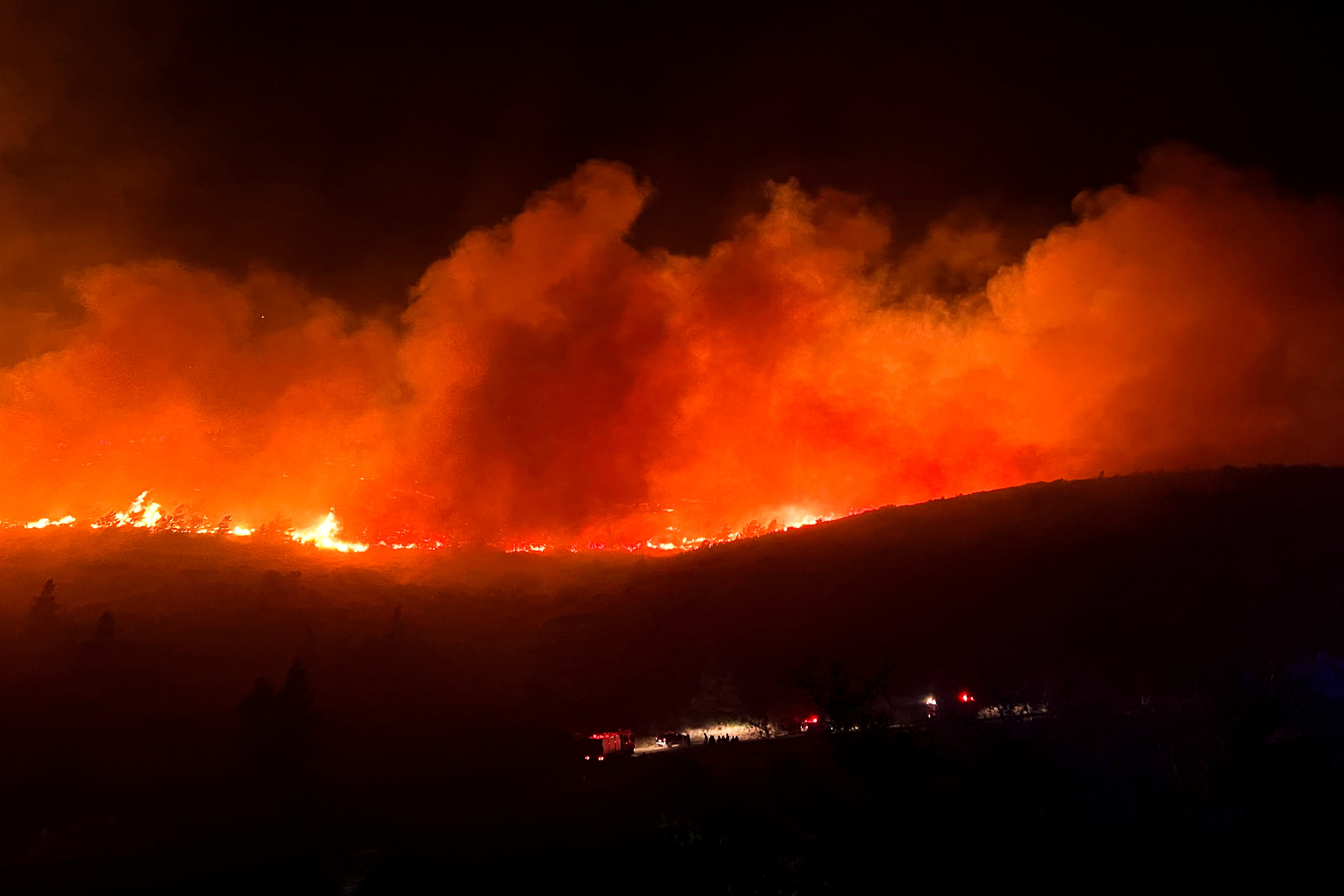 A wildfire burns in Ntrafi, north of Athens