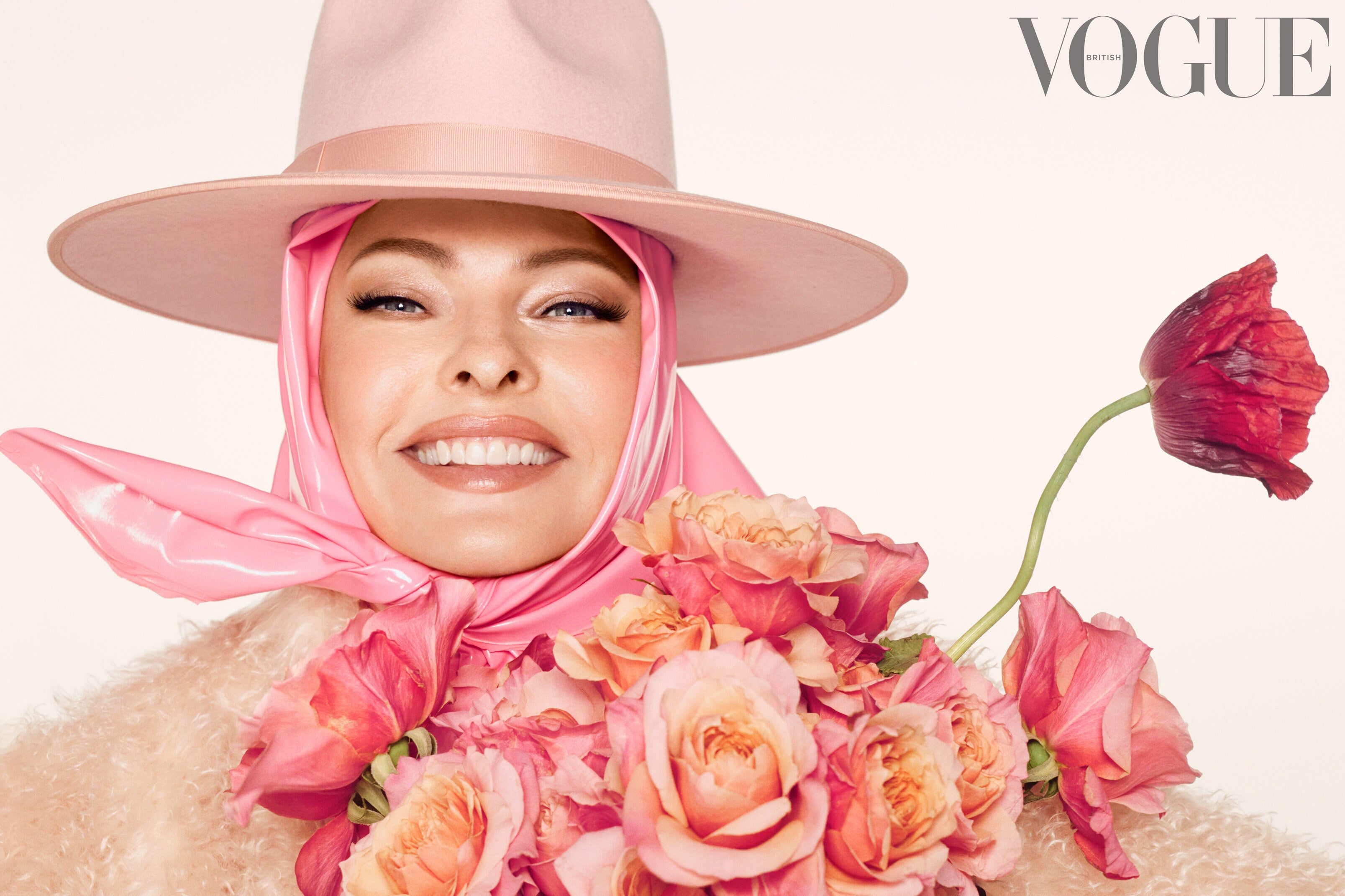 Linda Evangelista poses for British Vogue with face held with tape