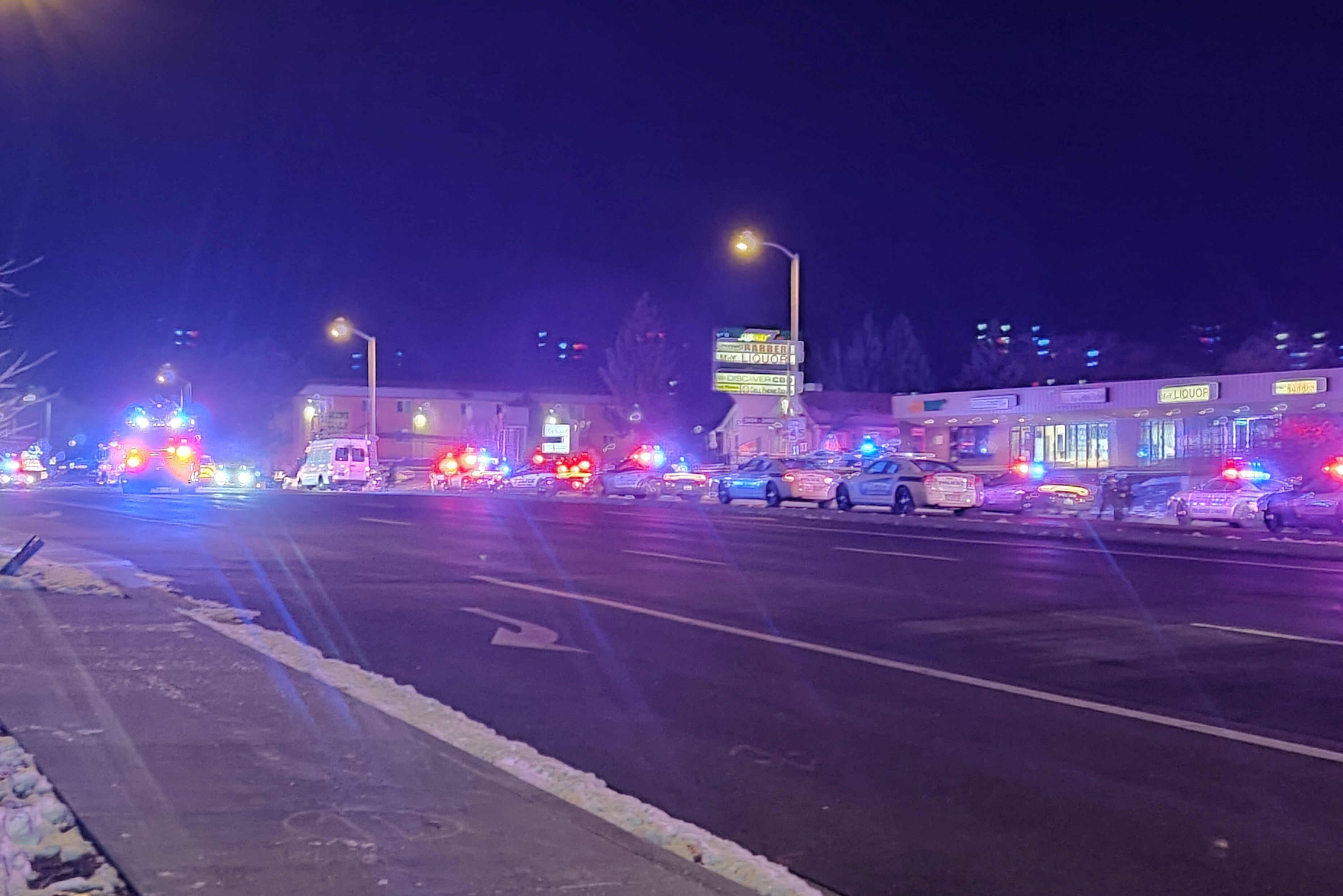 A view of various security and emergency vehicles parked on a street, after a shooting, in Colorado Springs