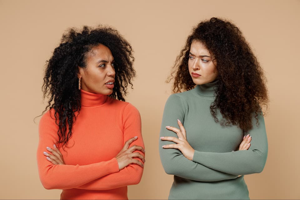Two,Frowning,Young,Curly,Black,Women,Friends,20s,Wearing,Casual