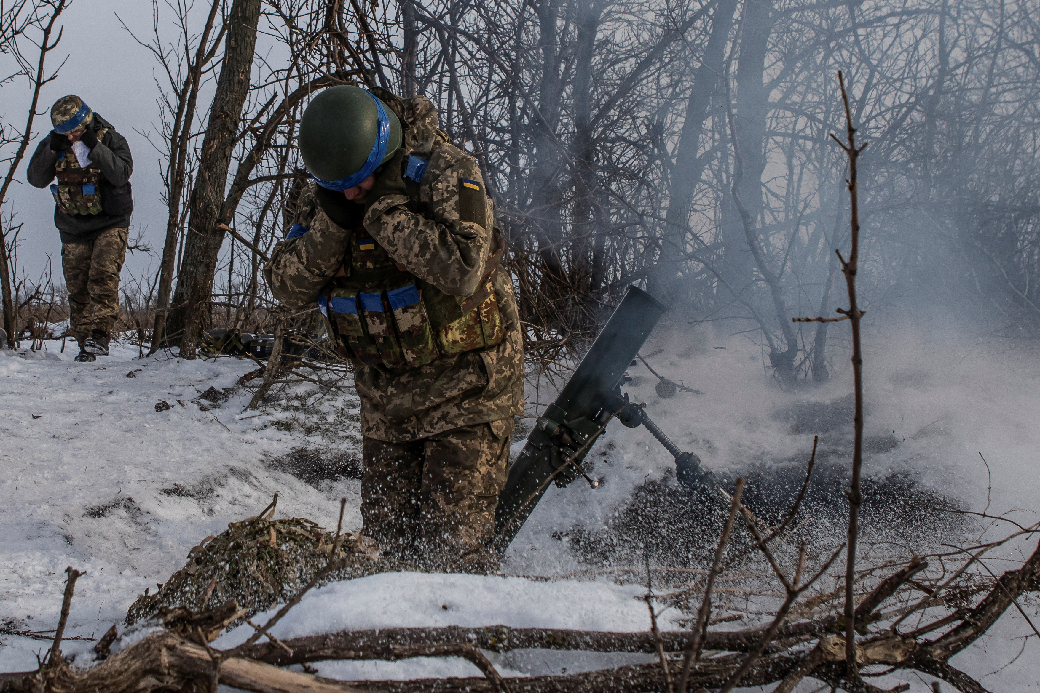 Ukrainian service members fire a mortar towards Russian troops in frontline near the Vuhledar town