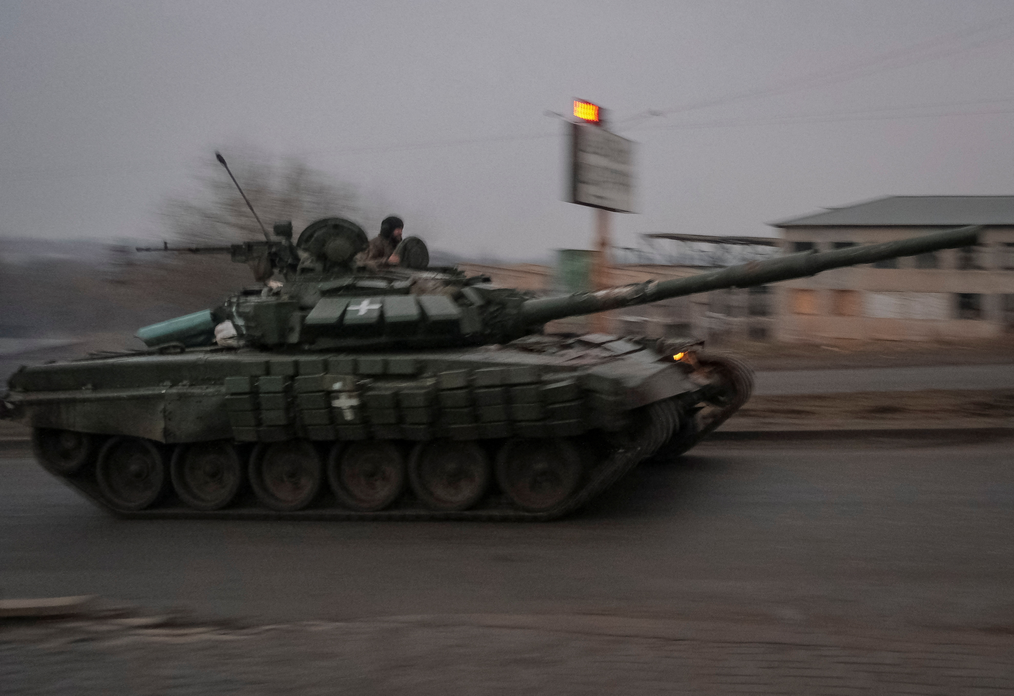 Ukrainian service members ride a tank near Bakhmut