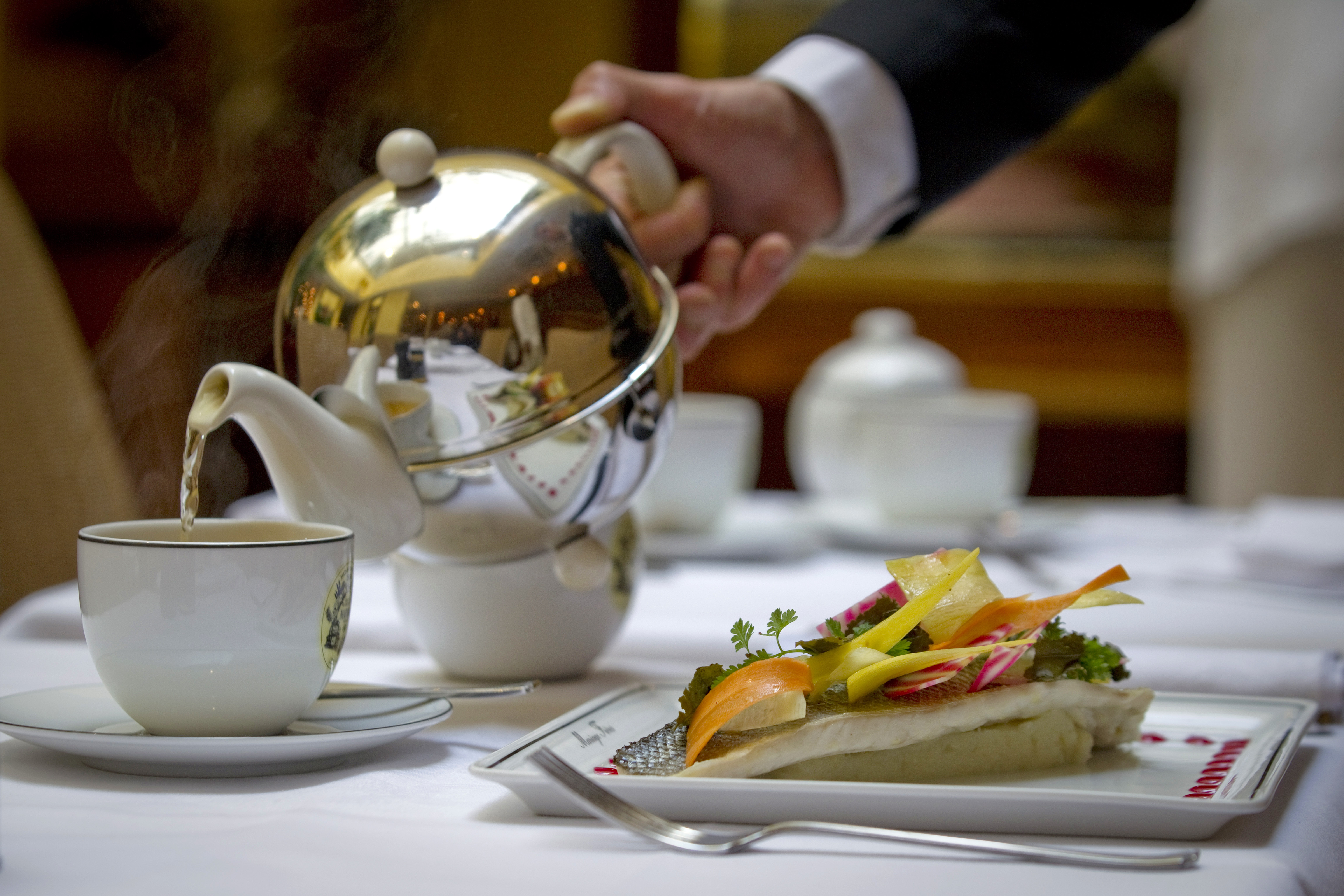 A waiter serves tea at the restaurant of