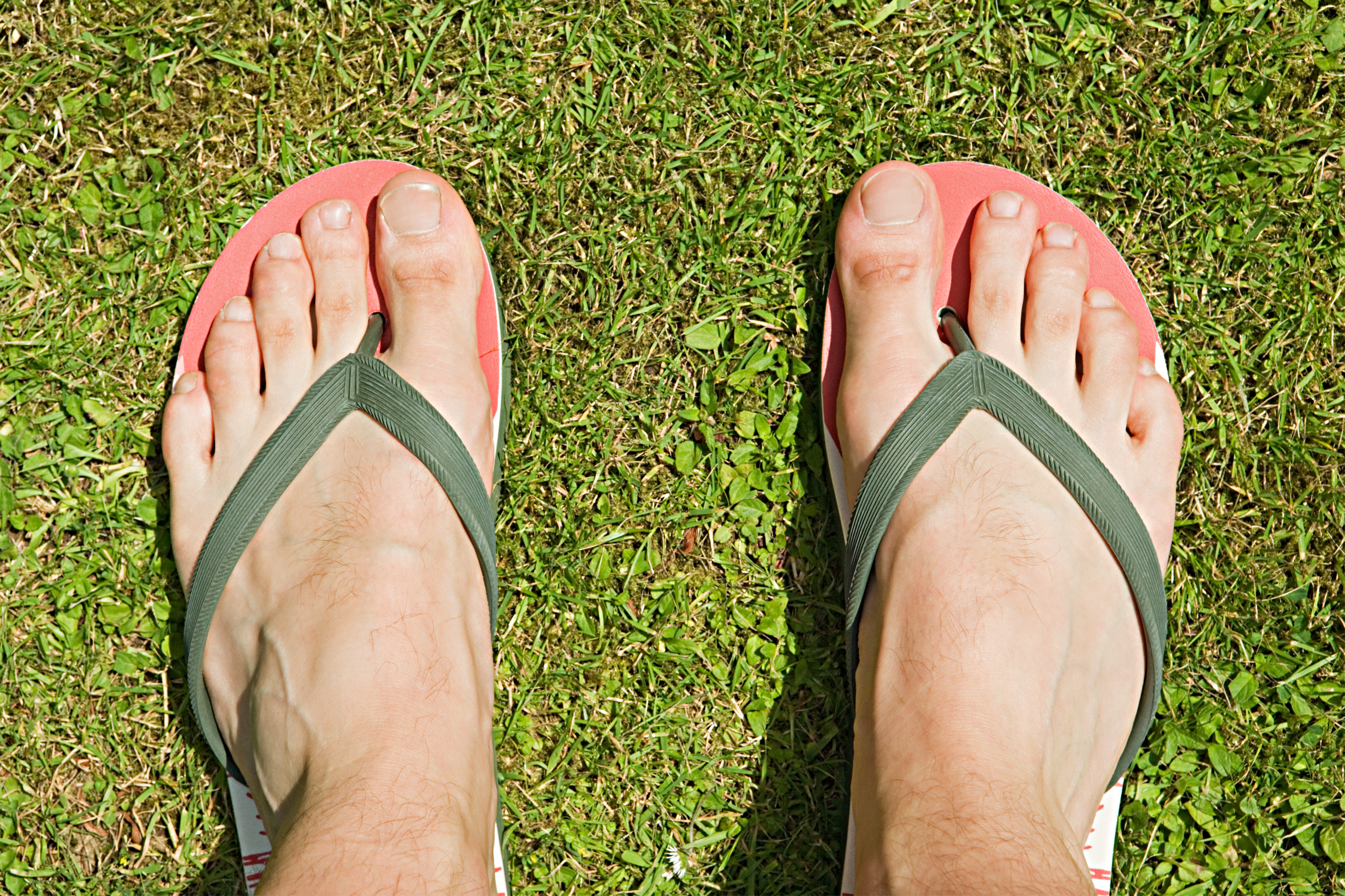 Feet of a man in flip flops