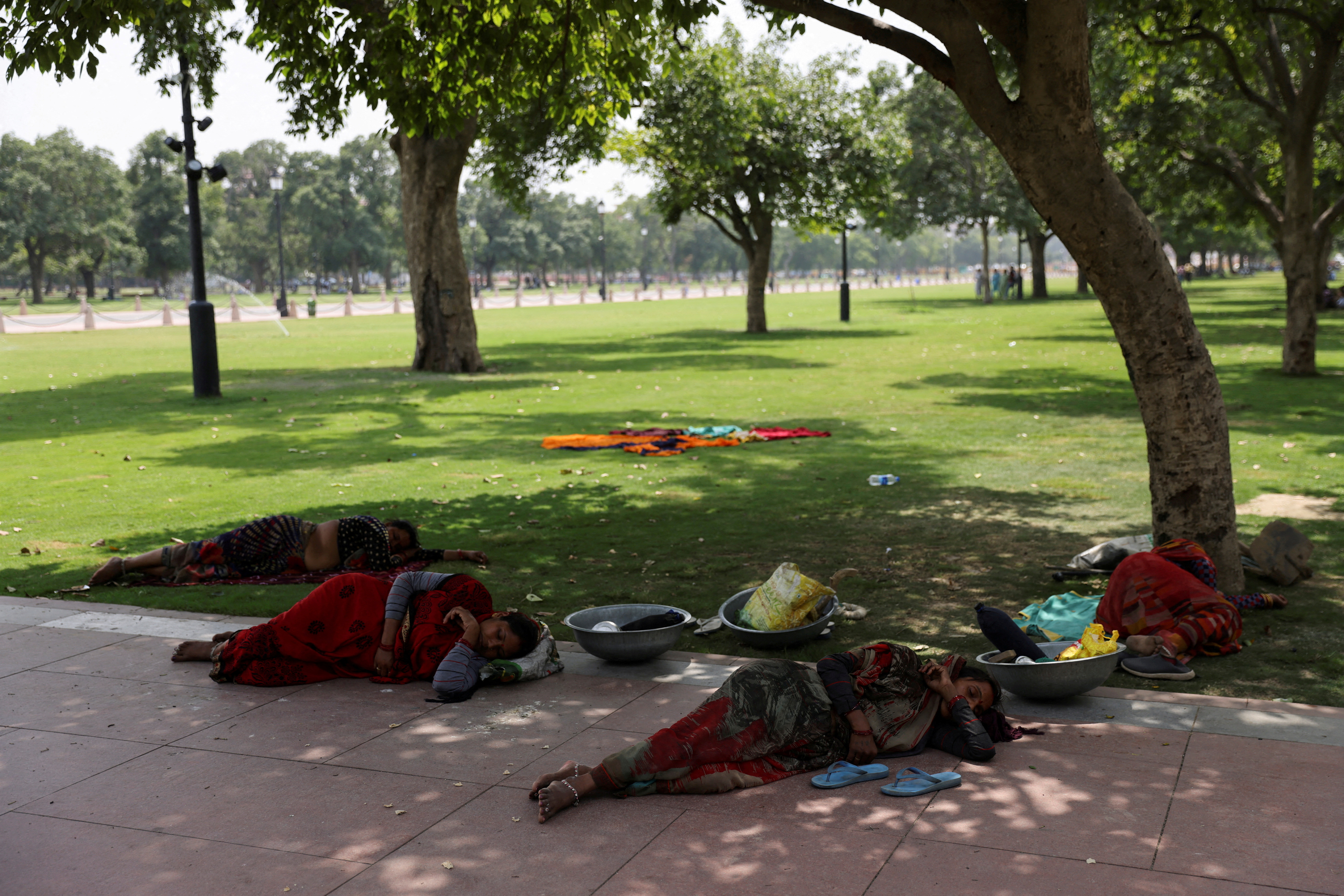 FILE PHOTO: Women labourers rest under a tree on a hot summer day in New Delhi