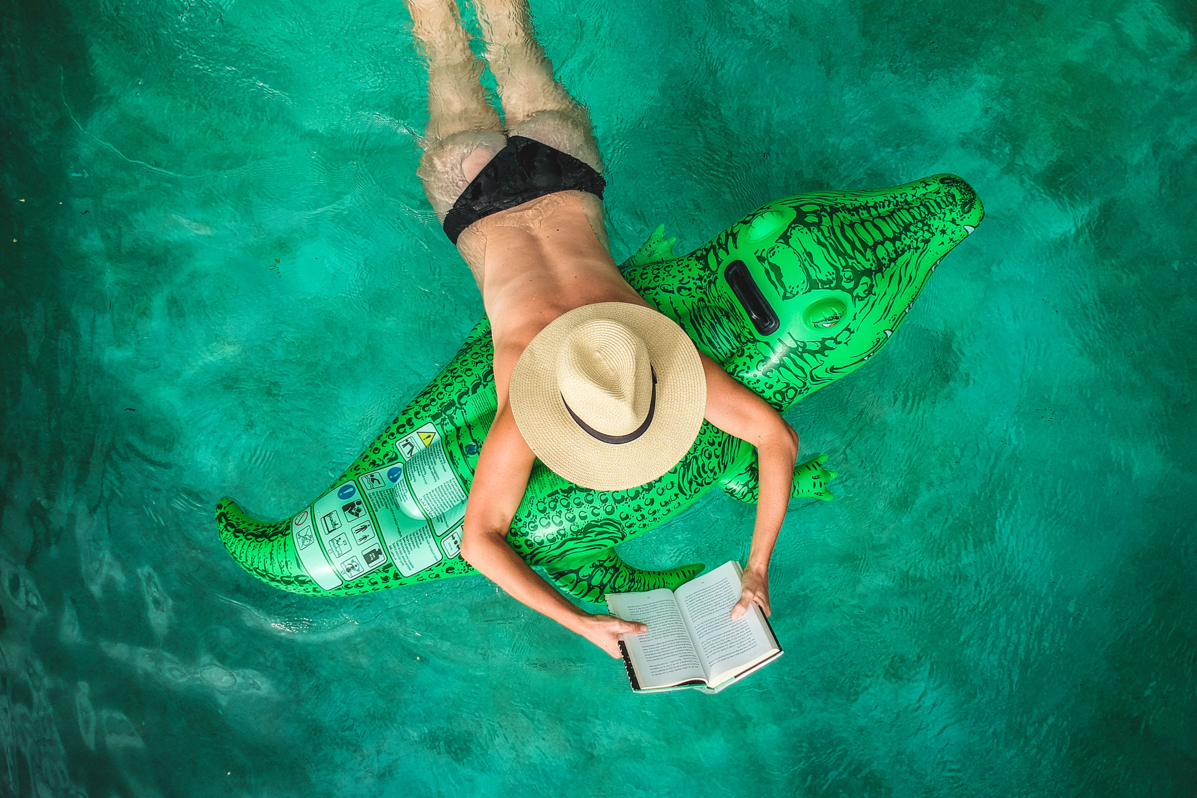 Woman in pool reading