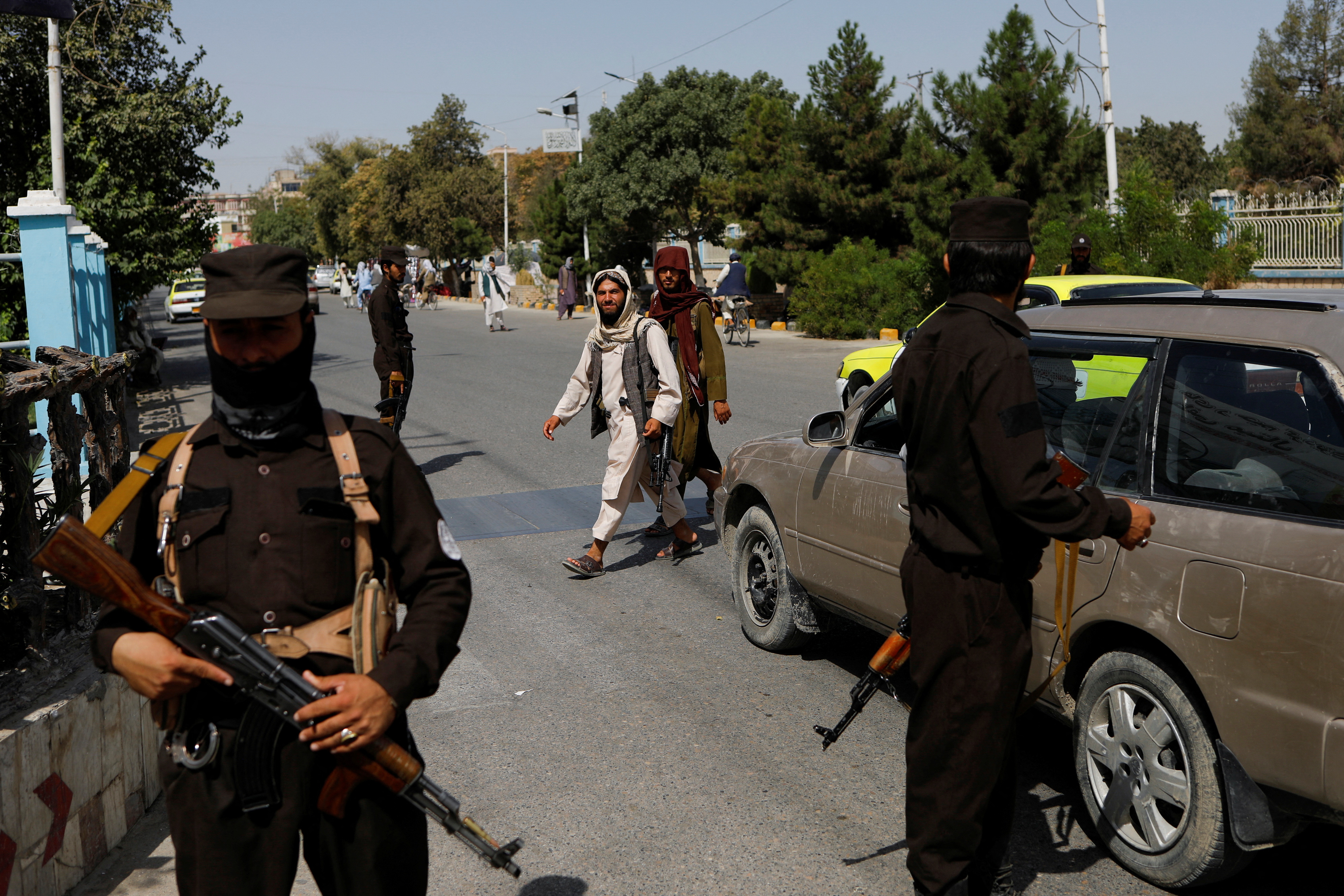 Taliban soldiers walk on a street in Mazar-i-Sharif