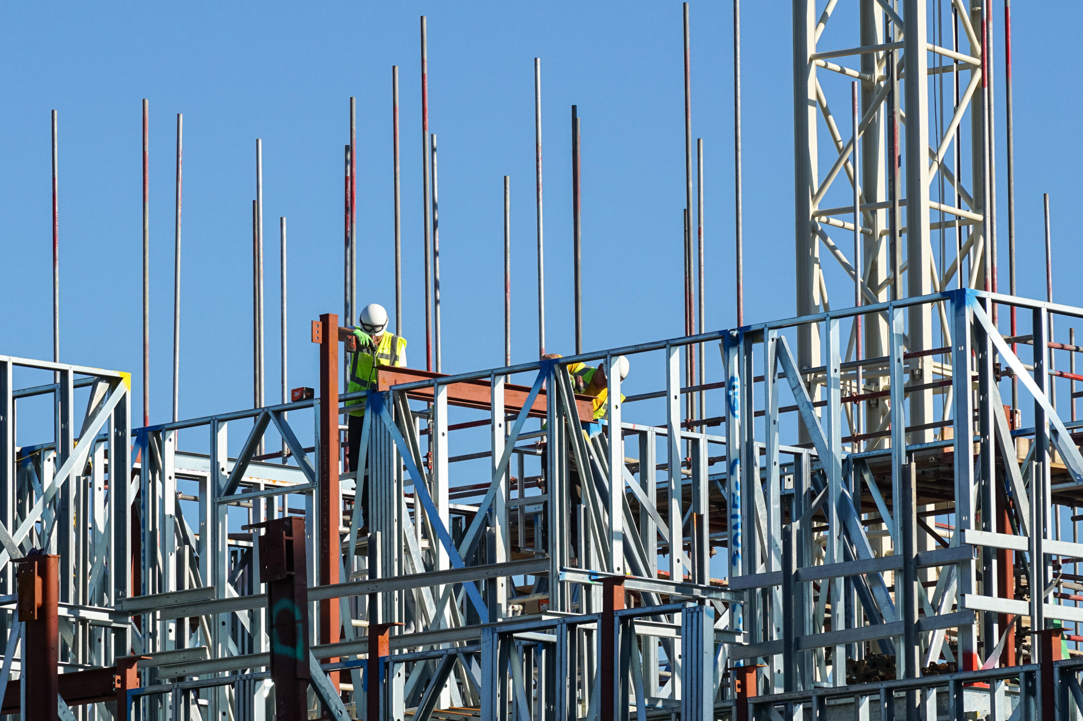 Builders working on construction site of residential building at Stratford, London England United Kingdom UK