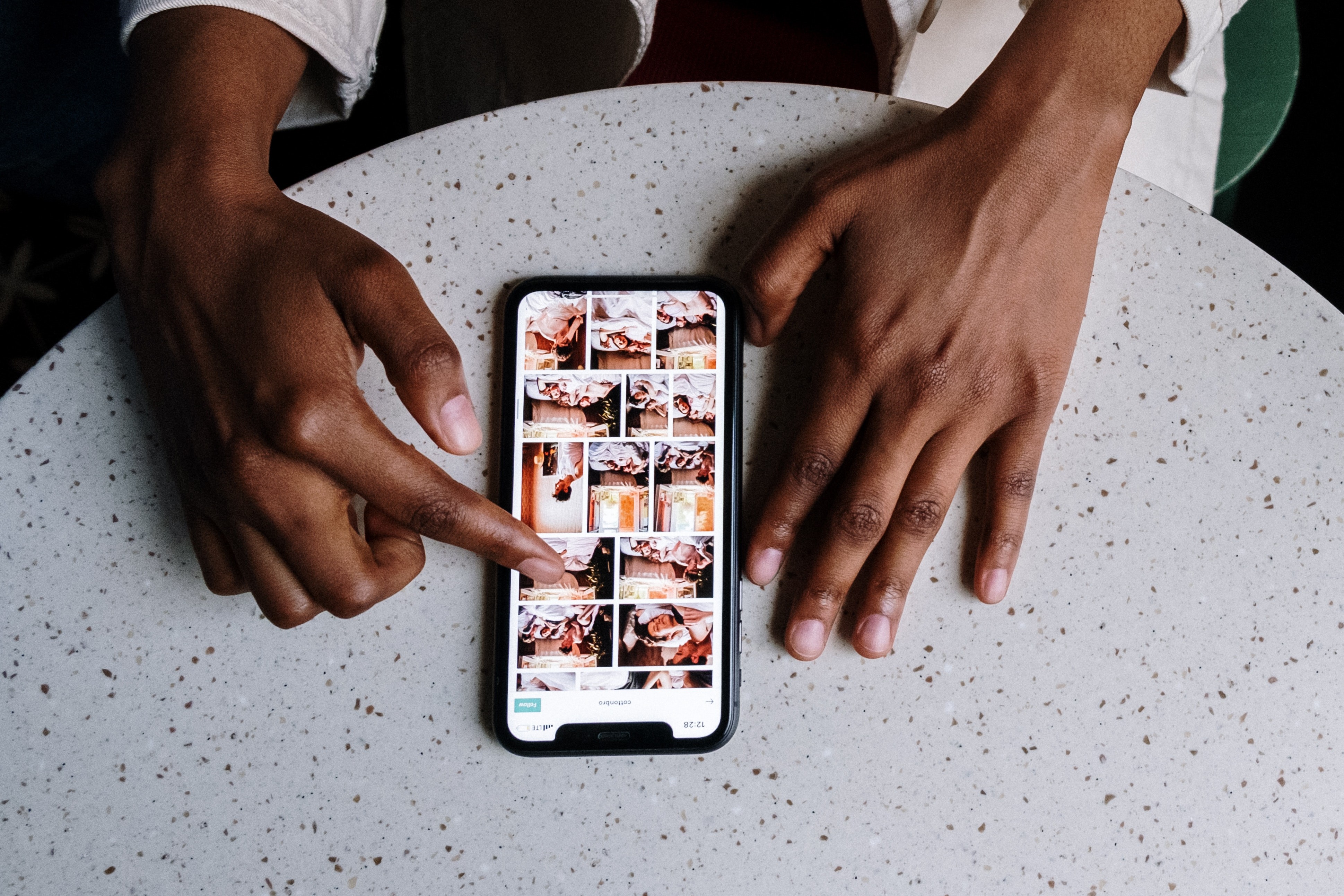 A man browsing photos on an iPhone