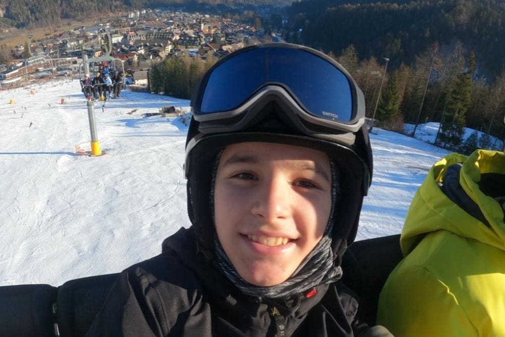 Teenager who broke back in sledging accident returns to the slopes