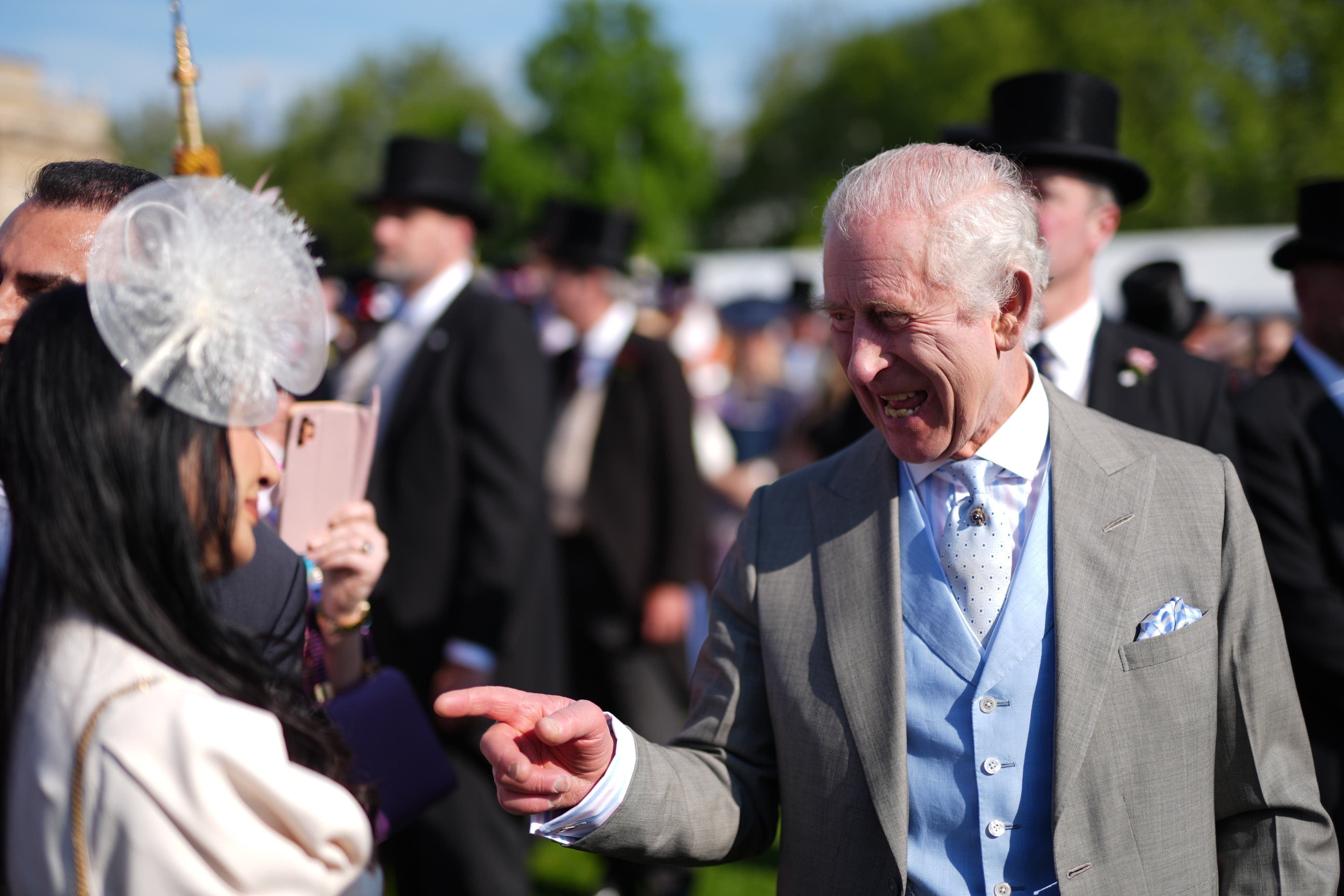 King in good spirits with guests at Buckingham Palace garden party