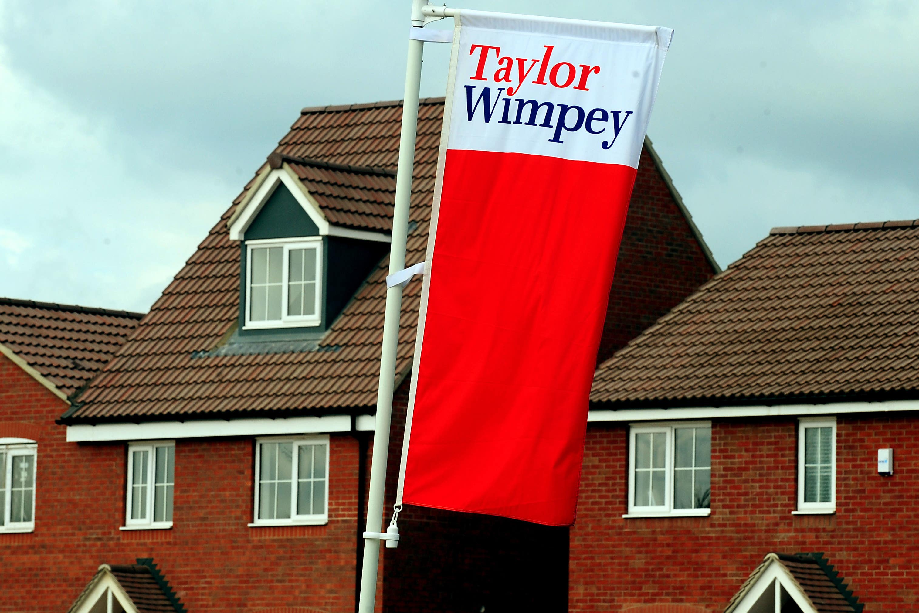 Taylor Wimpey CEO backs "ambitious" government house building targets as profit falls before interest rate cut