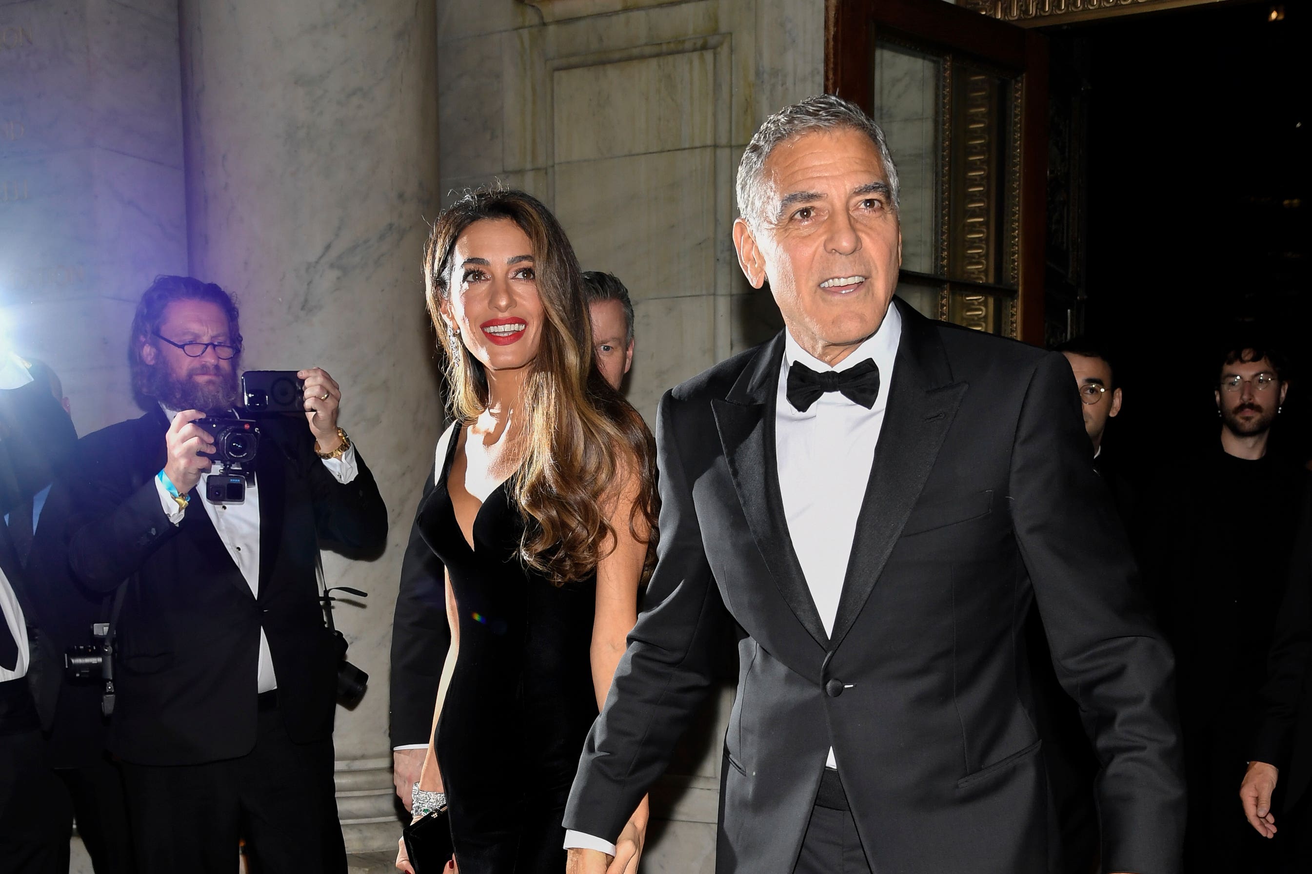 George Clooney plays photographer at star-studded charity event