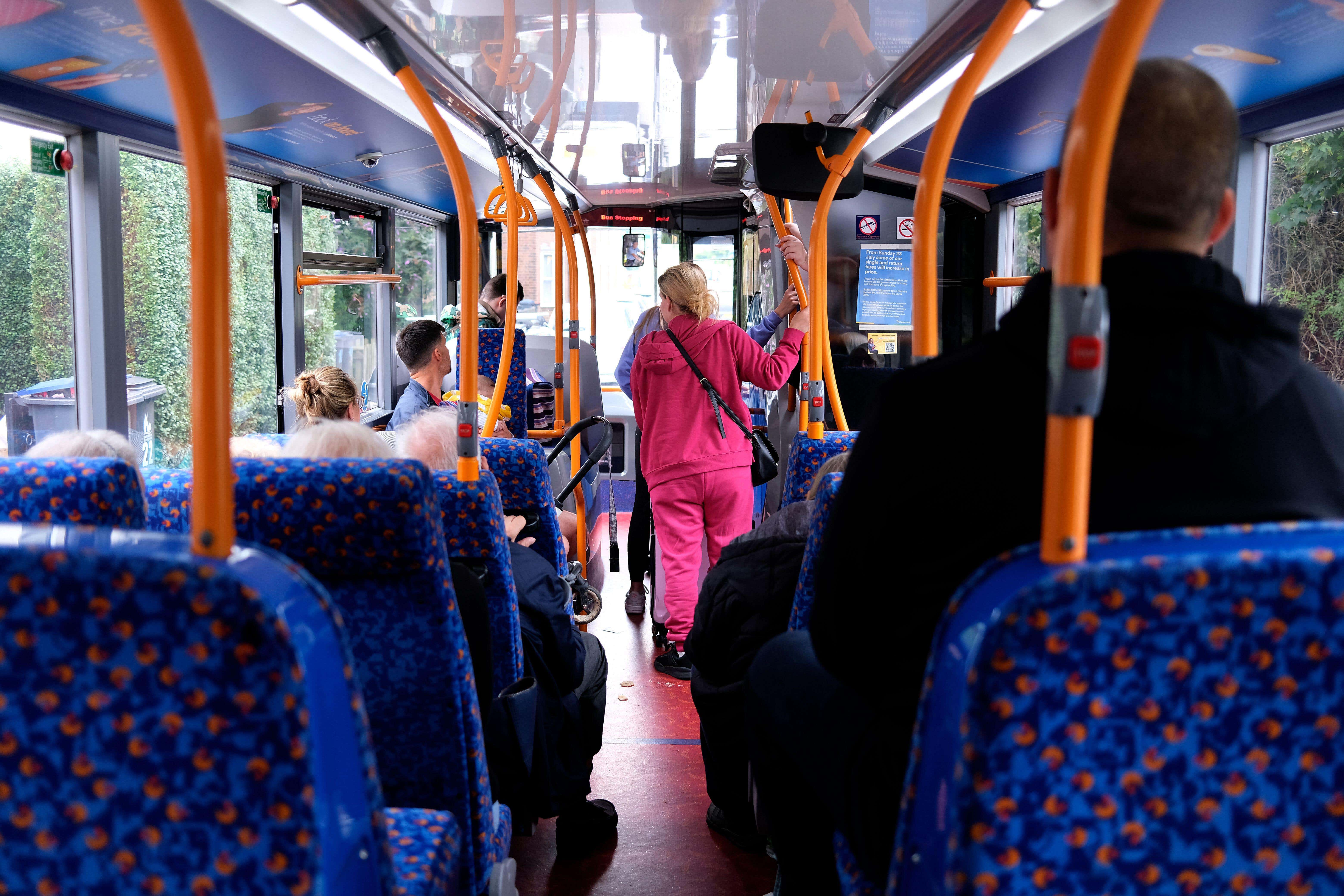 passengers standing inside bus