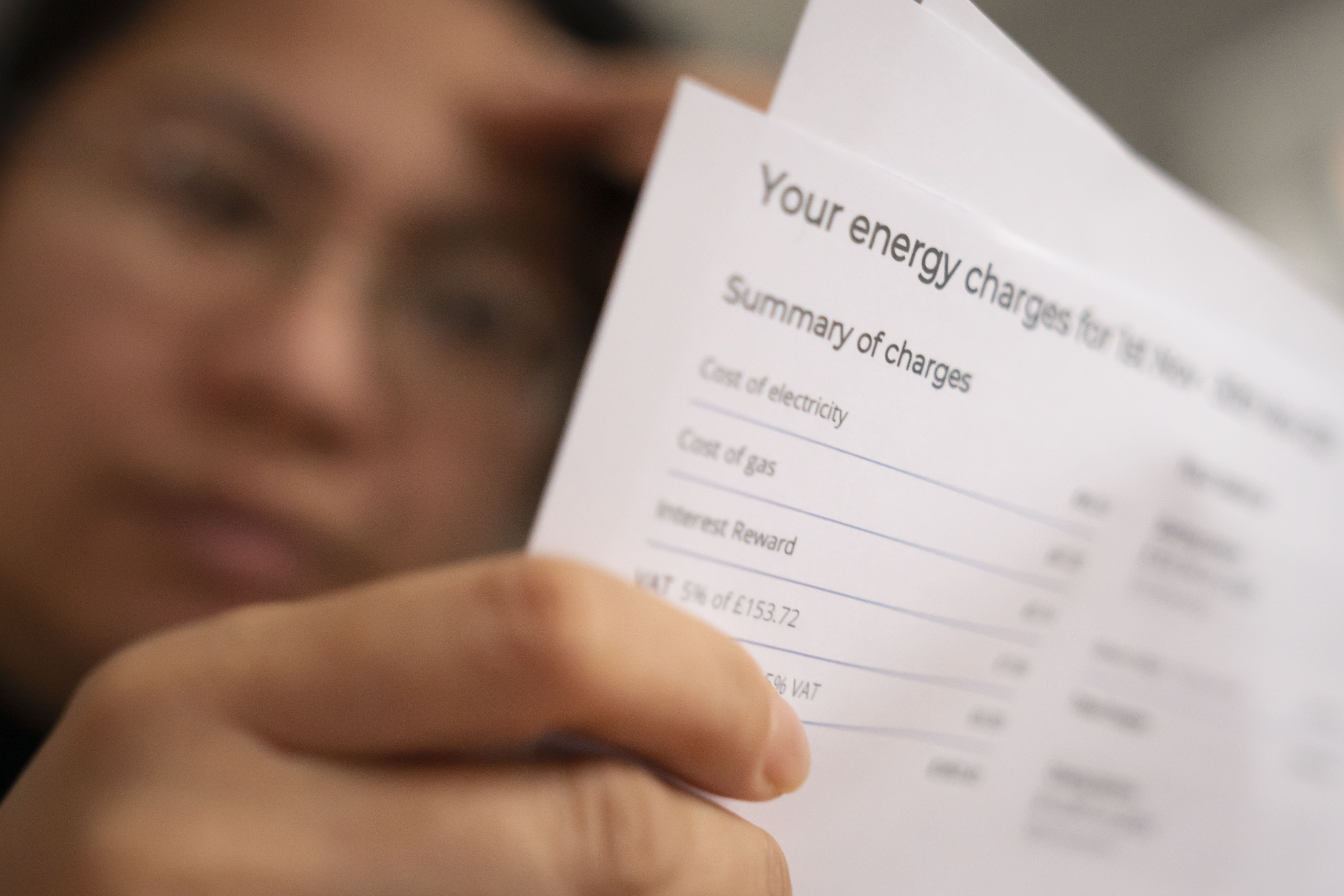 person stressed looking at energy bill
