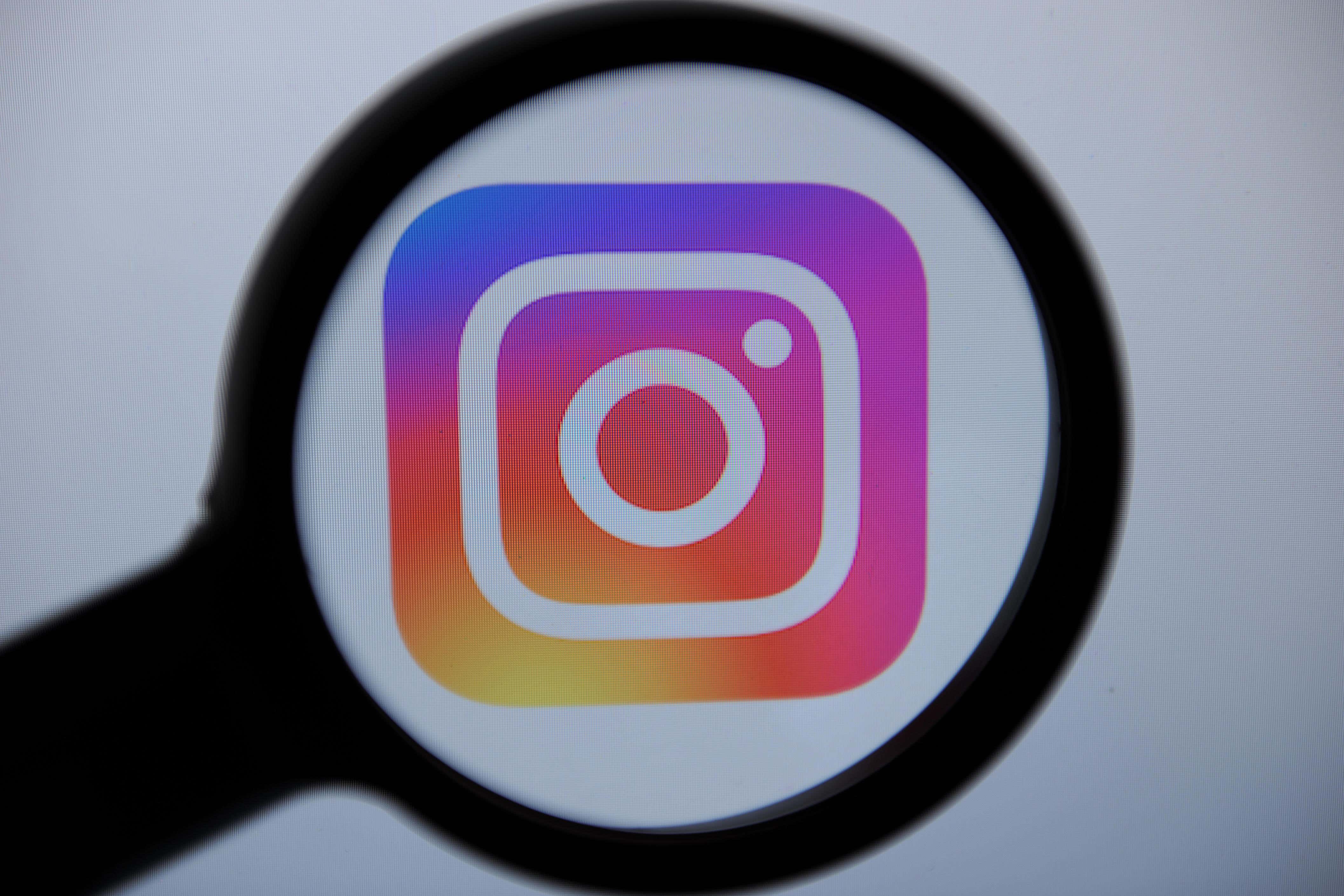 A close up of the Instagram logo being inspected