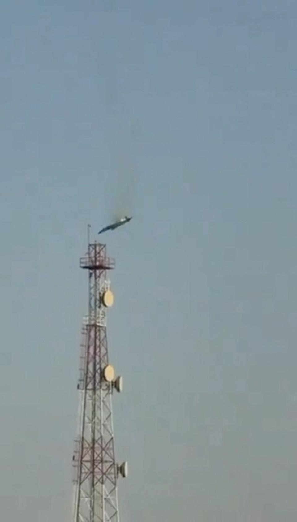 A burning aircraft falls from the sky in Al Jahra, in this still image obtained from social media video