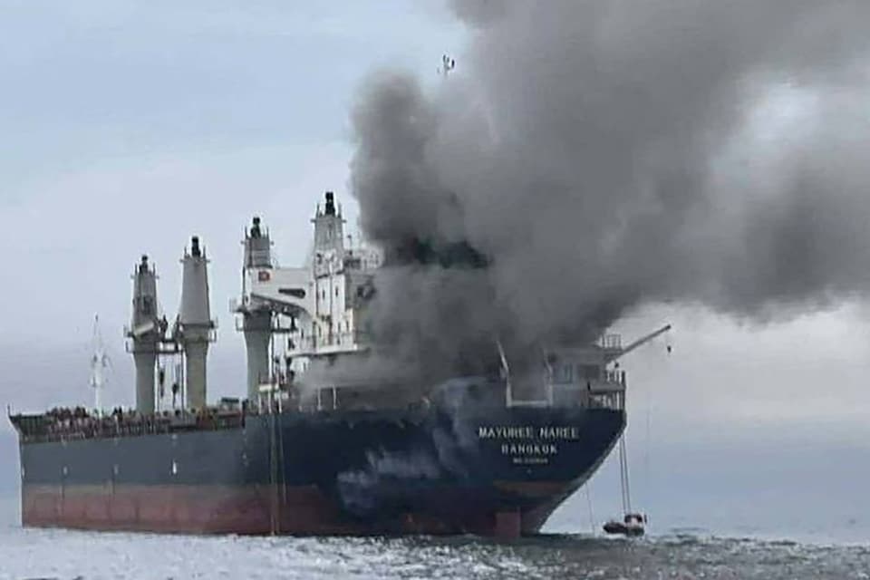 <p>Smoke spewing off the Thai bulk carrier 'Mayuree Naree' near the Strait of Hormuz after an attack</p>