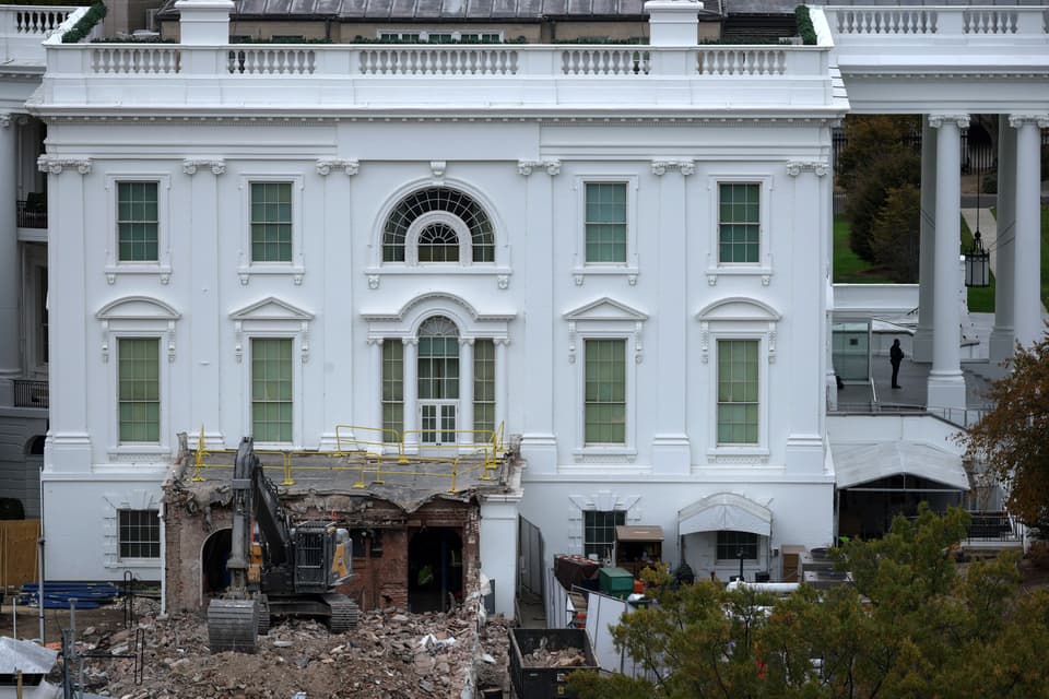 A digger demolishing the east wing