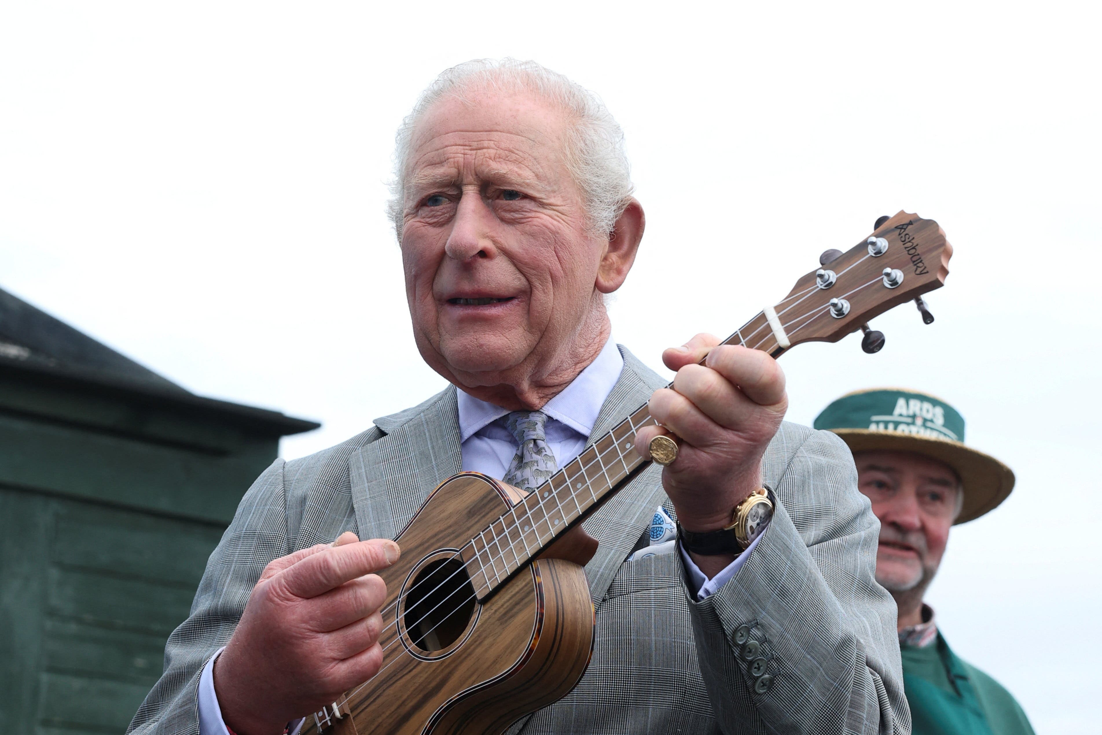 Charles shows off ukulele skills as Camilla enjoys ice cream during royal visit