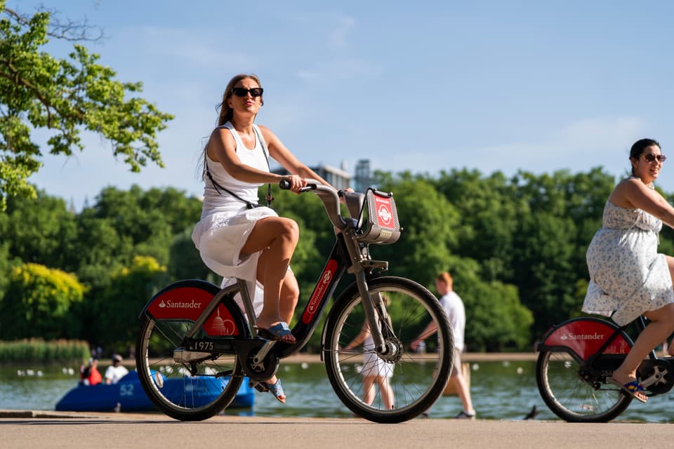 <p>A woman rides on a Santander cycle during the hot weather in Hyde Park, London. The record for the hottest May day has been broken again, with provisional temperatures reaching 35C, the Met Office has said. Temperatures on Tuesday surpassed Monday's provisional all-time hottest meteorological spring temperature of 34.8C recorded in Kew Gardens in south-west London. Picture date: Tuesday May 26, 2026.</p>