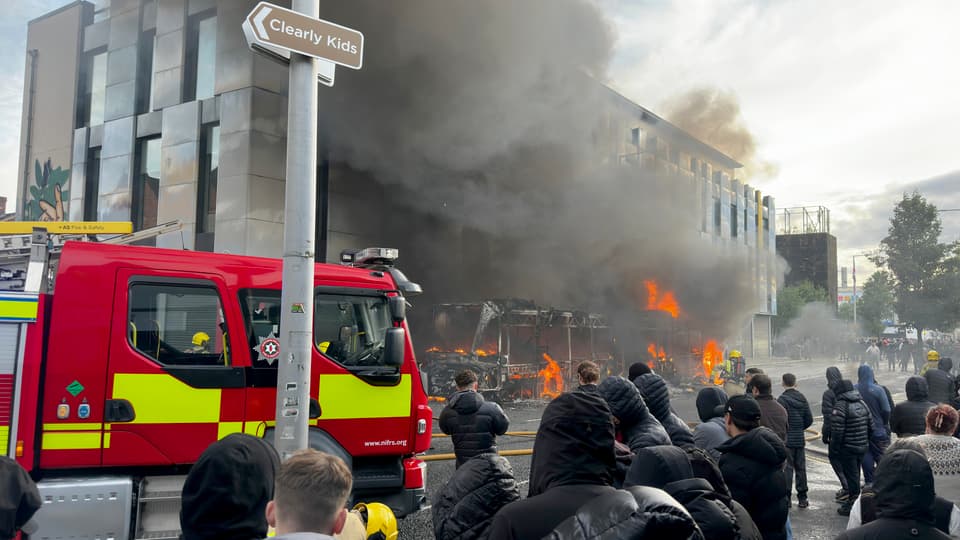 <p>Emergency services tackle the blaze after a bus was set on fire</p>