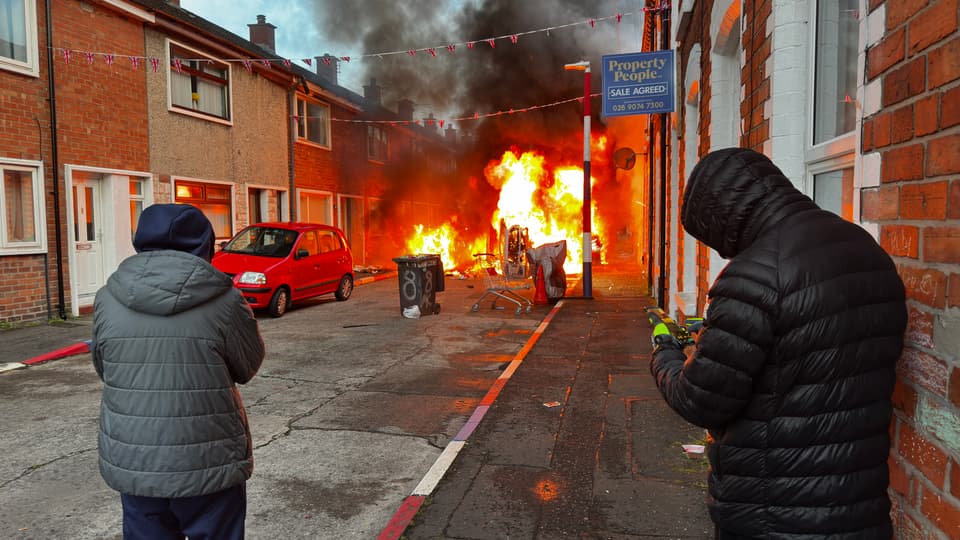 <p>Vehicles set on fire by protesters on Lendrick Street in Belfast</p>