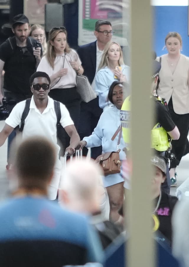 <p>Andy Burnham (centre top) arrives at London Euston train station </p>