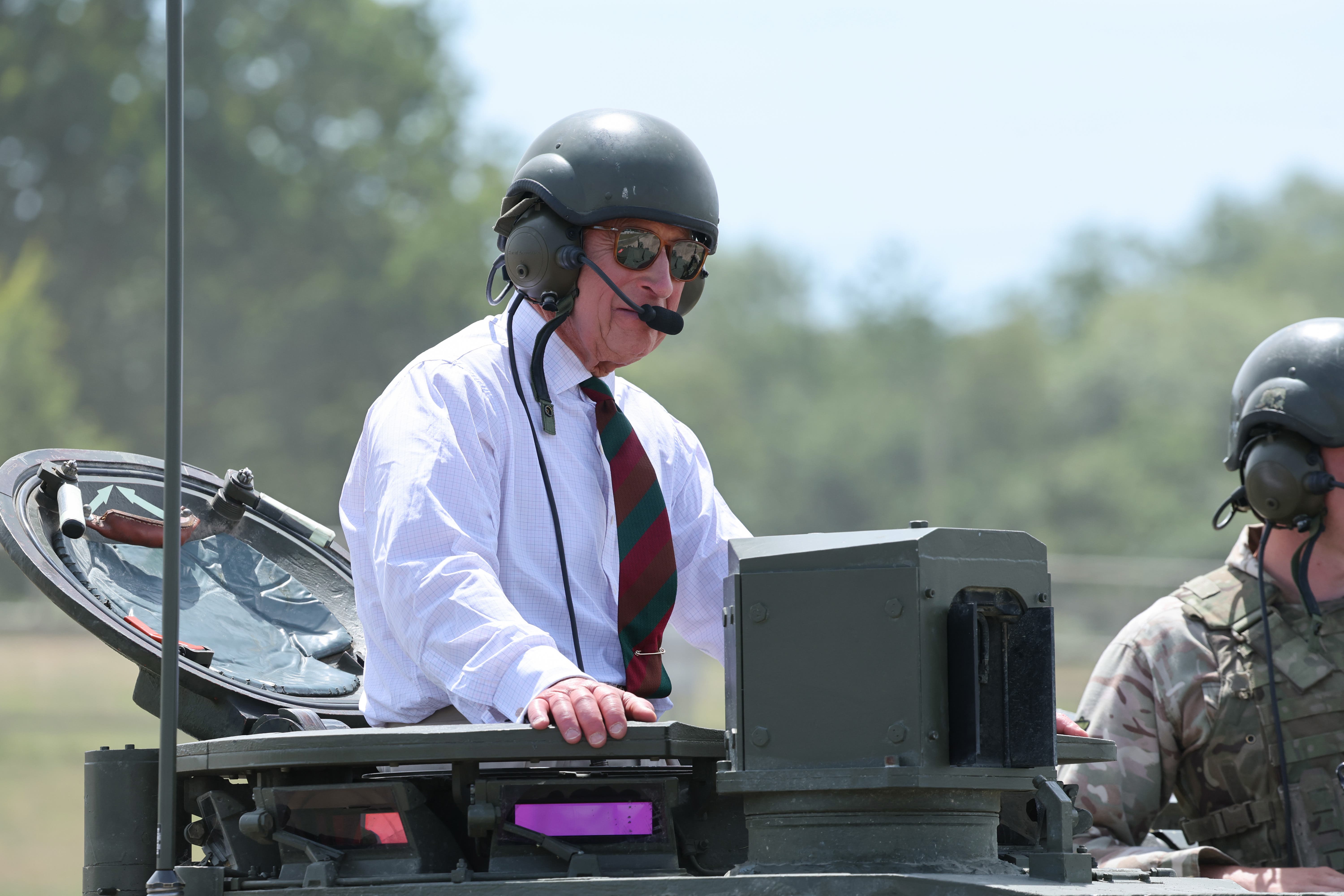 Heavy metal: King rides British Army tank in visit to regiment