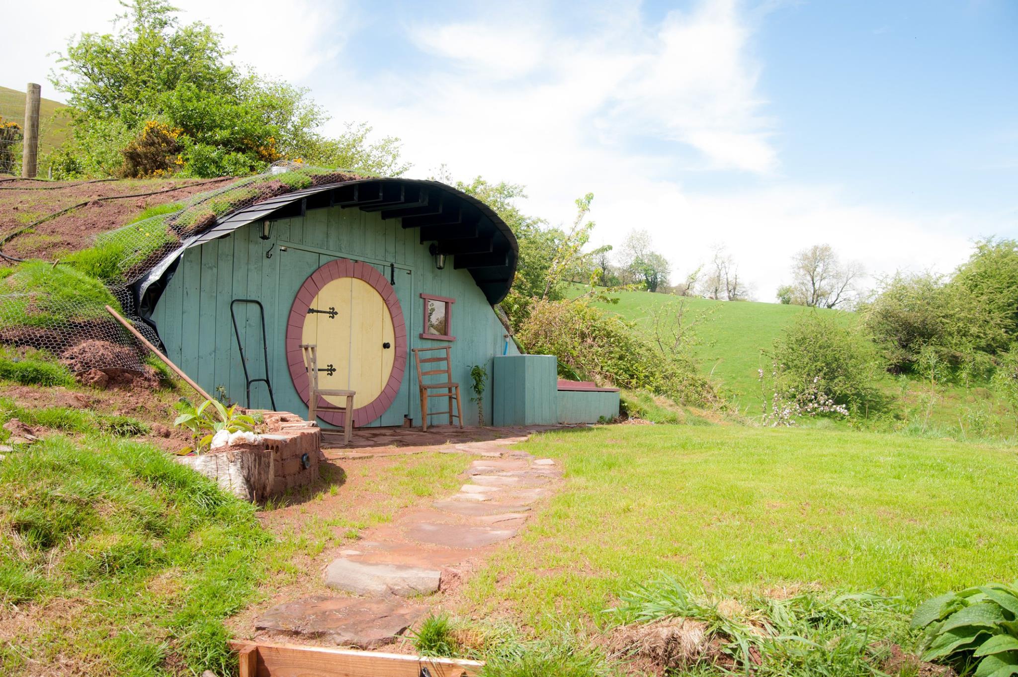 Former granary with quirky Hobbit House rental in the garden for sale