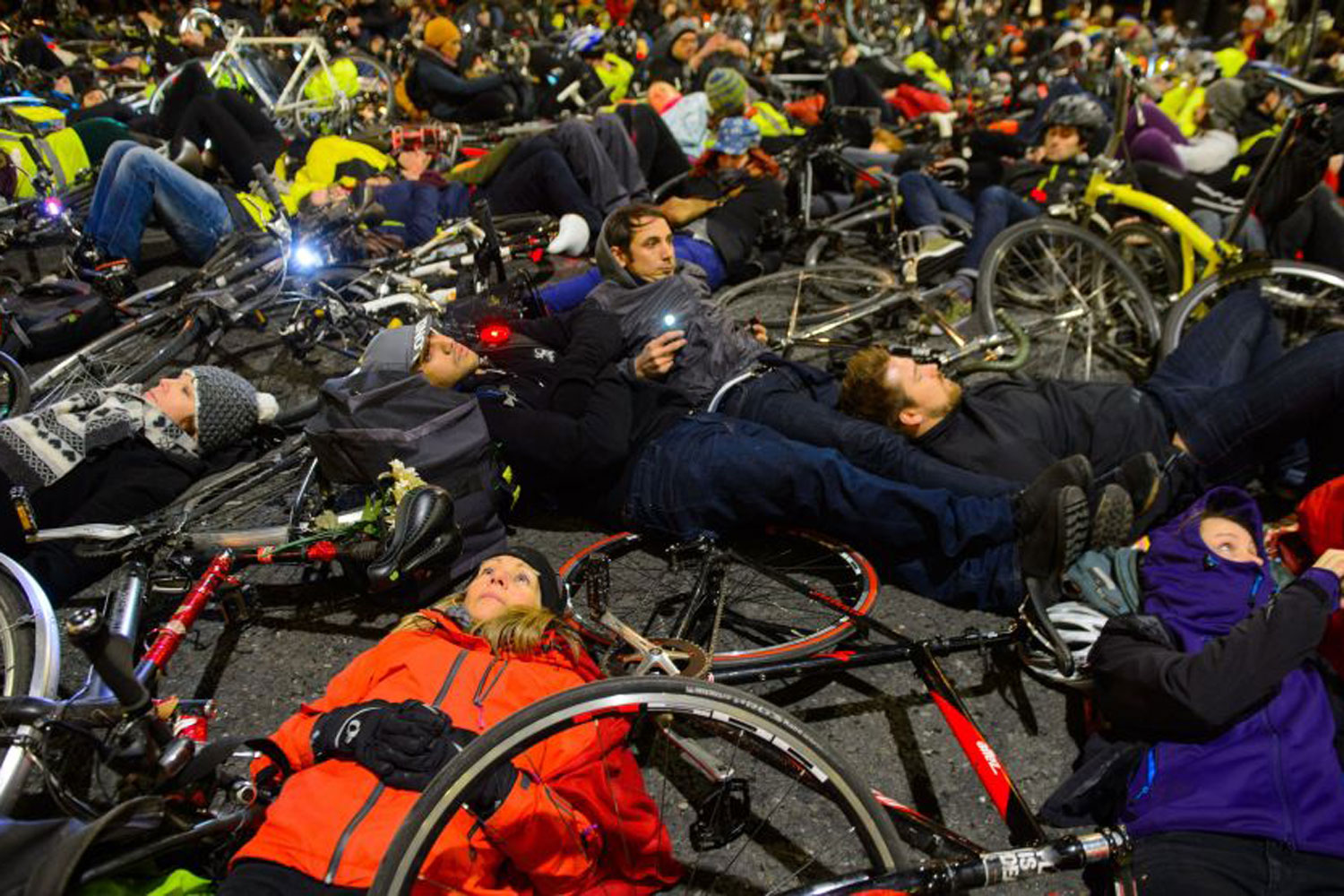 Thousands of cyclists lie down in the road for rush hour protest 