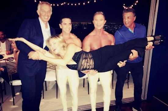 Tony Blair helps Sylvester Stallone carry Kate Hudson in bizarre photo