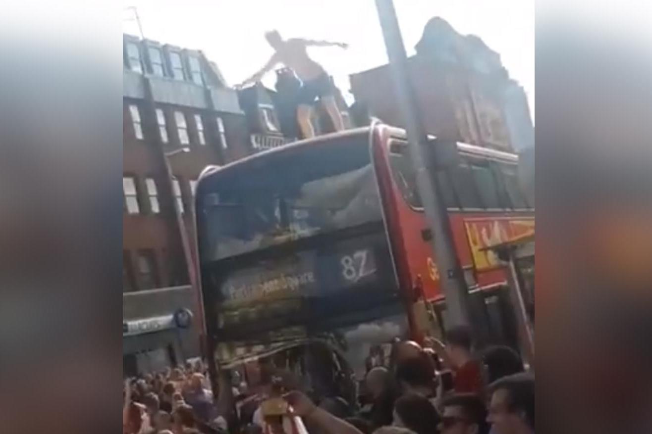 Safety warning as football fans jump off buses and climb taffic lights