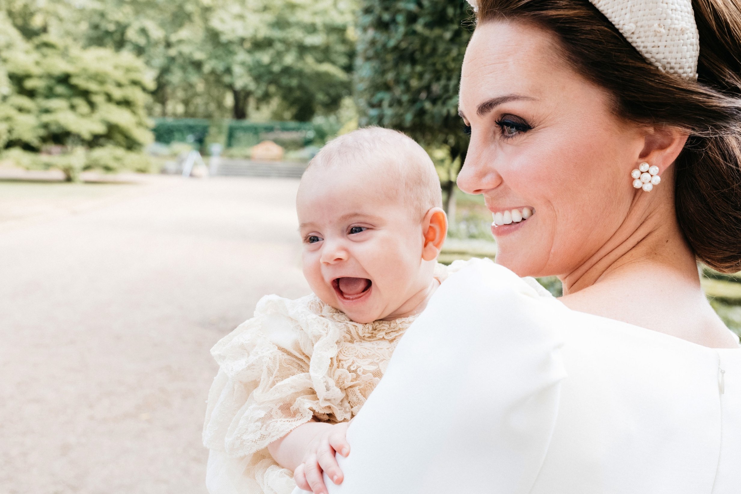 Adorable new photo shows Prince Louis smiling in his mother's arms