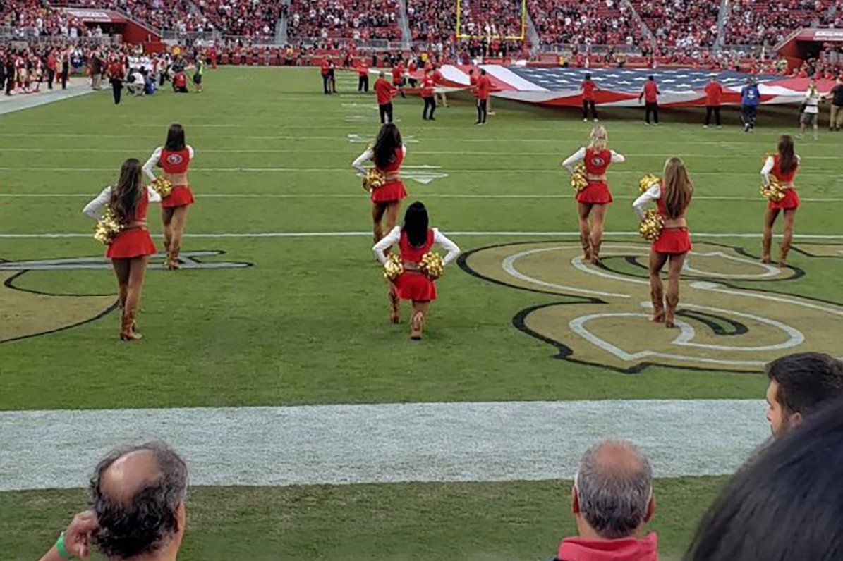 Lone cheerleader takes the knee in protest at NFL game