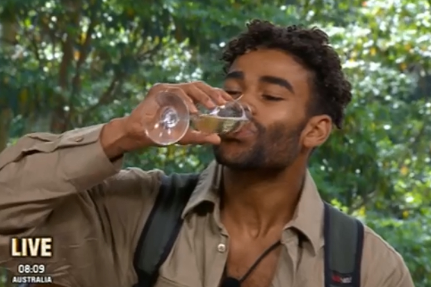 Malique downs glass of champagne as he's kicked out of I'm A Celeb