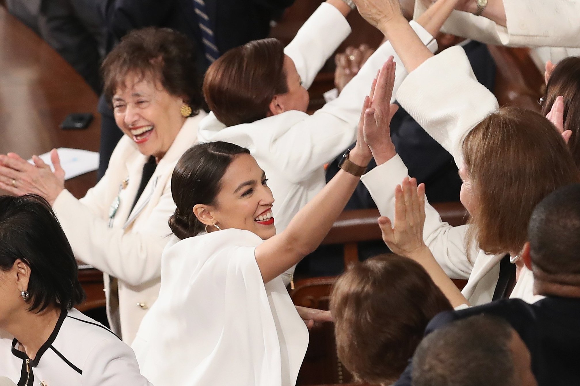 Women in white cheer after nod from Trump in State of the Union speech